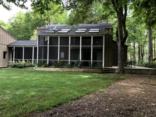 Macatawa House | Secluded Woodland Retreat Home with Creekside Deck Near Macatawa Beach in Macatawa, Michigan