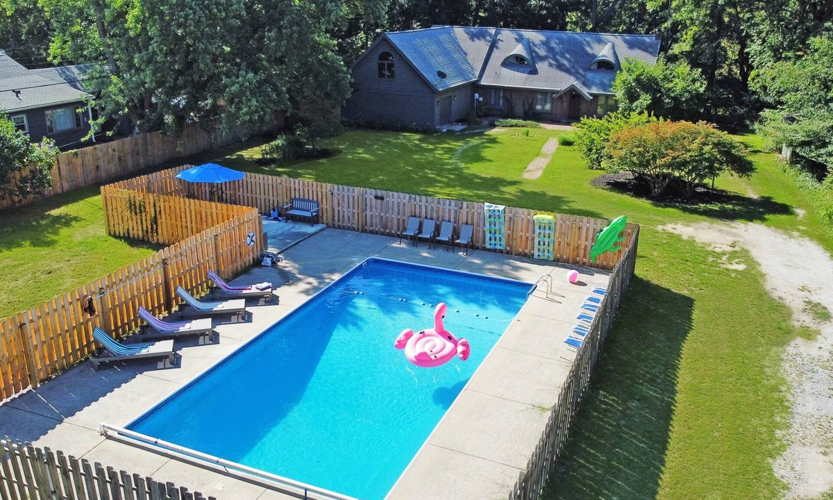 Fair Plain House | Spacious group getaway with heated pool, sauna, basketball court, and firepit. Sleeps up to 15 guests and is just minutes from Lake Michigan beaches and downtown St. Joseph. Perfect for family vacations, group trips, and relaxing Southwest Michigan.