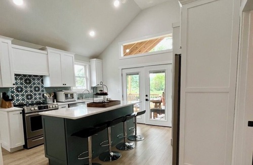 Dowling House | Bungalow on the water offers a canoe, paddle boards, paddle boat, fishing gear.