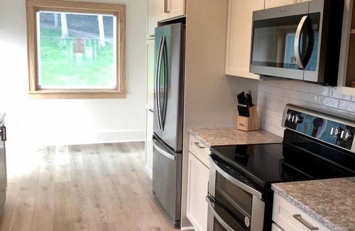 Macatawa Cottage | Charming Waterfront Cottage with Modern Remodel Overlooking Lake Macatawa Harbor, Near Macatawa, Michigan