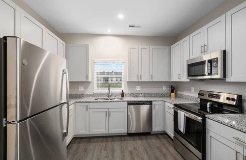 Grandville Apartment | Modern 16BR 16BA Condos w Garage and Patio