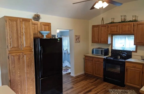 Colton Cottage | Riverfront Cottage with Hot Tub, Kayaks, Canoes, & Fishing Boats!