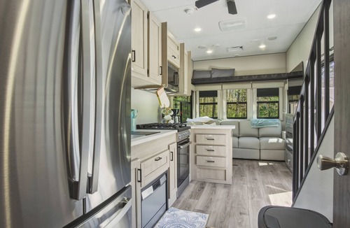 Fountain House | Round Lake Getaway Camper: Full Kitchen, 2 BR's, Dock, Pedal Boat Near Ludington