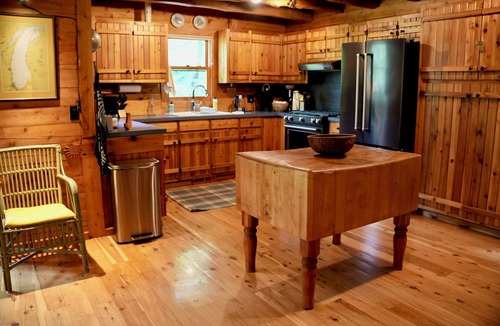 West Olive Cottage | Upscale 4-bedroom, 3 full bathroom lakeside log cabin in West Olive, Michigan.