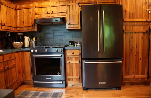 West Olive Cottage | Upscale 4-bedroom, 3 full bathroom lakeside log cabin in West Olive, Michigan.