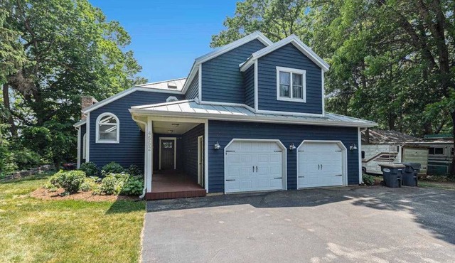 Serene lakefront retreat with an expansive deck, dock access, game room, & AC